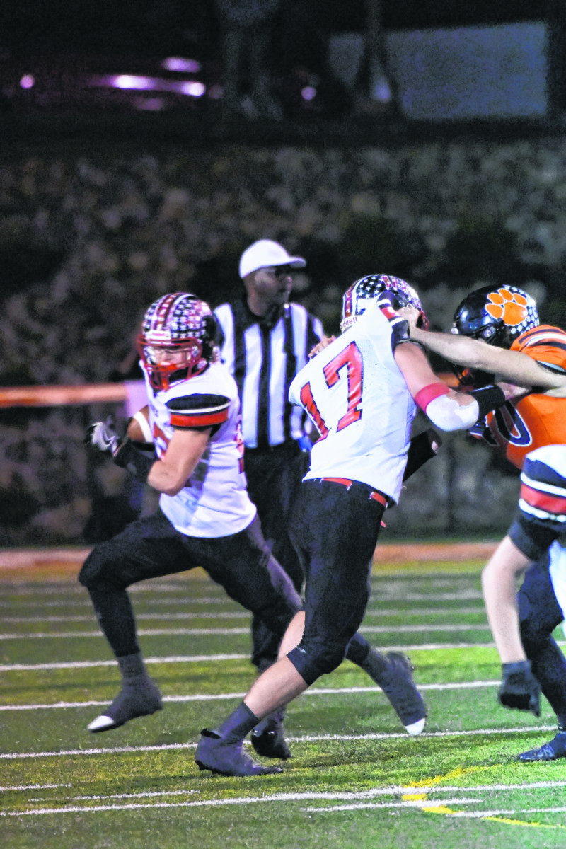 Brownstown Central's Lucas Hines blocks for teammate Jayden Steinkamp during the Braves' 33-20 loss Friday night at Lawrenceburg in the opening round of the Class 3A Sectional 31 tournament.