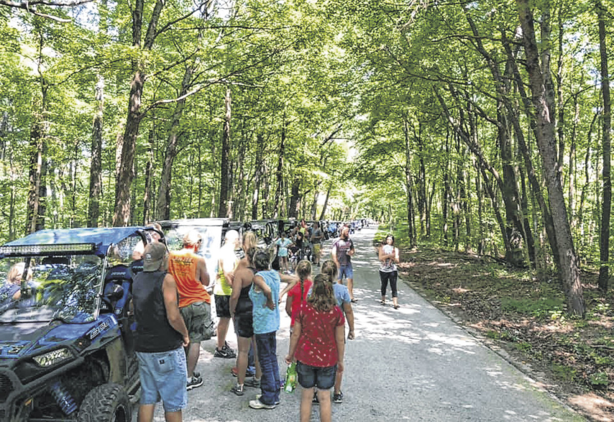 People riding in side-by-sides stop along a scenic road in Jackson County for a break during Saturday's inaugural ride organized by Luke's Country Inn.