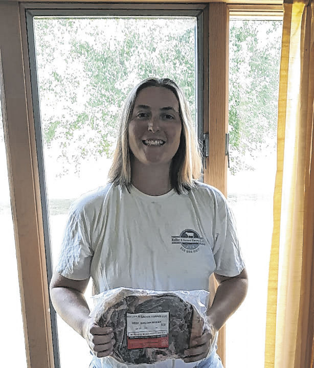 Maria Grove of Roller and Grove Farms in Medora holds one of their freezer-wrapped Angus beef products available at the Seymour Area Farmers Market.