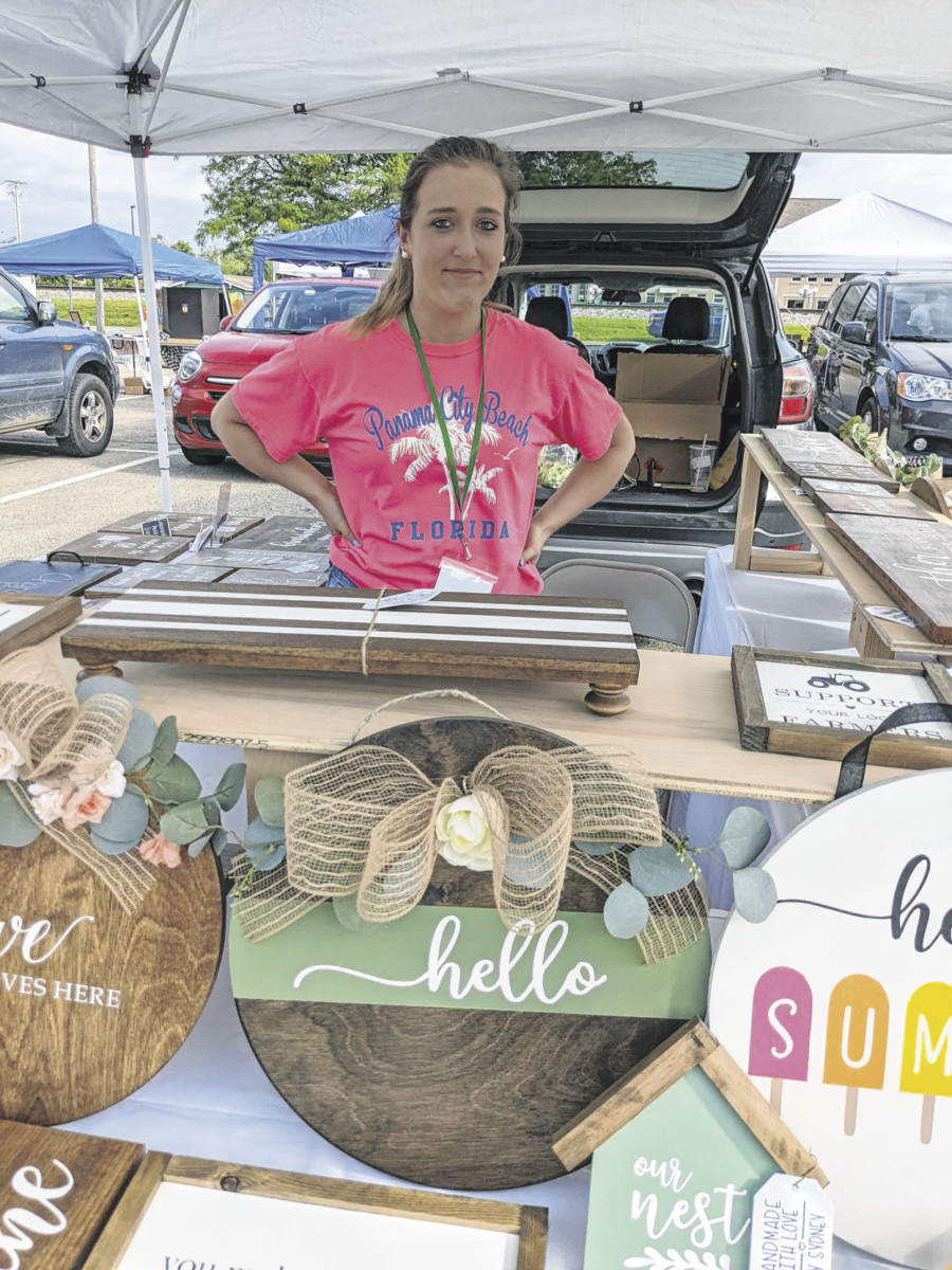 Sydney Bullard, owner of Sydney’s Wood Creations, sells wood signs, door hangers, decorative trays, stove top covers and wood projects at the Seymour Area Farmers Market.  SUBMITTED