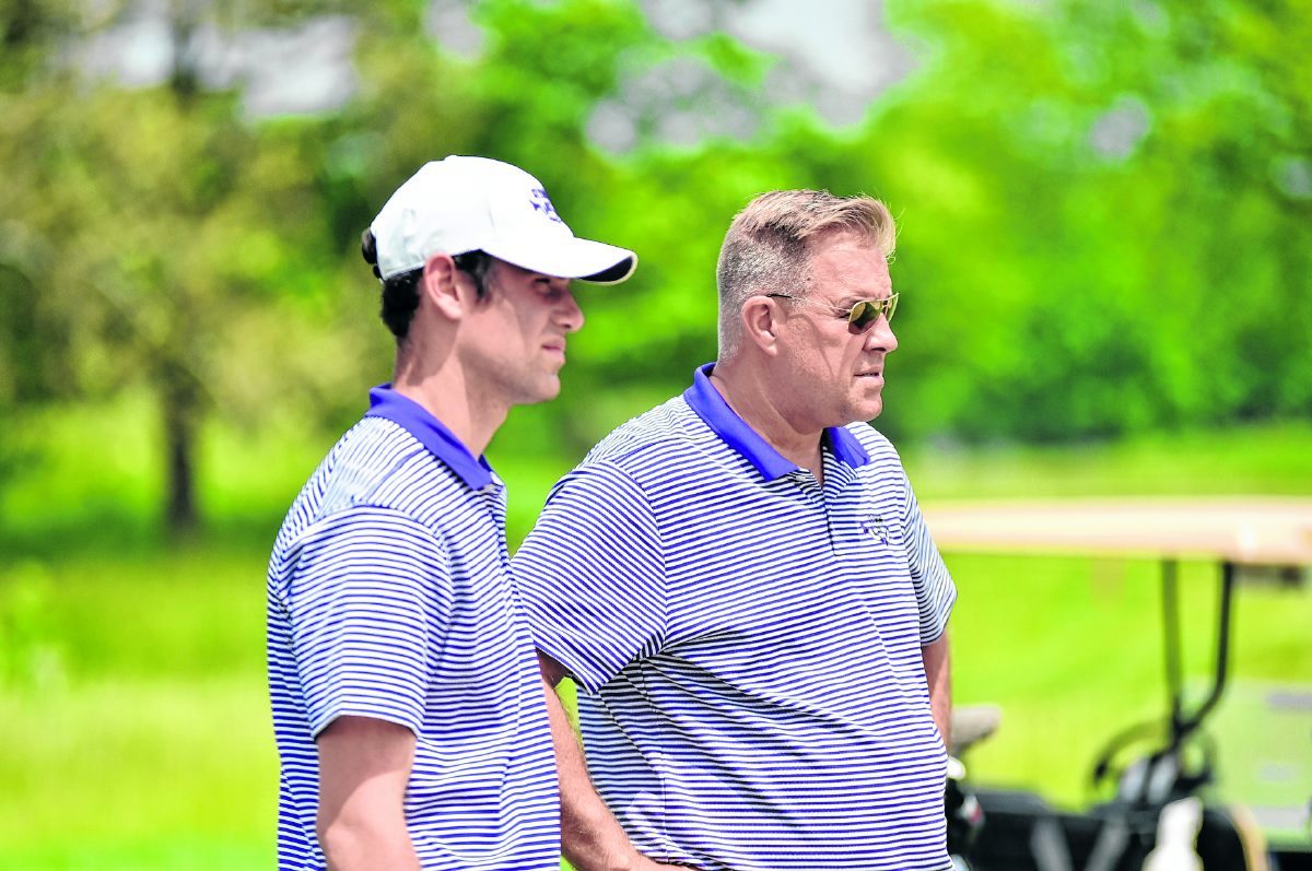 Seymour senior Owen Marshall and Seymour golf coach Jim Hoffman watch a member of Marshall's foursome putt during the Hoosier Hills Conference Tournament on Saturday at Shadowood Golf Course.  Arv Koontz/ The Tribune