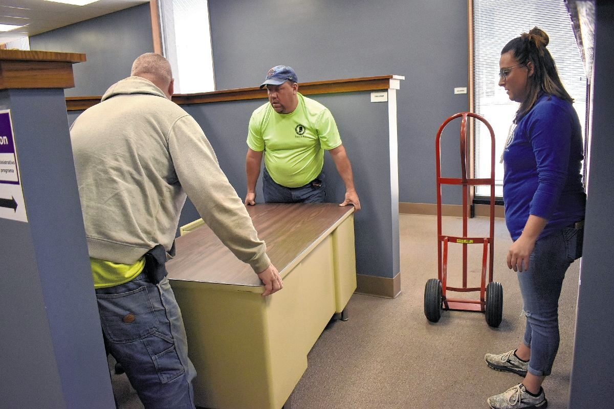 Seymour Parks and Recreation Department employees, from left, Dave Wilson, Dennis Dunn and Tonya Disque spent Monday moving office furniture from city hall across the street to the former Reedy Financial building at 211 N. Chestnut St. The temporary move will allow for an emergency renovation project at city hall.  Submitted photo