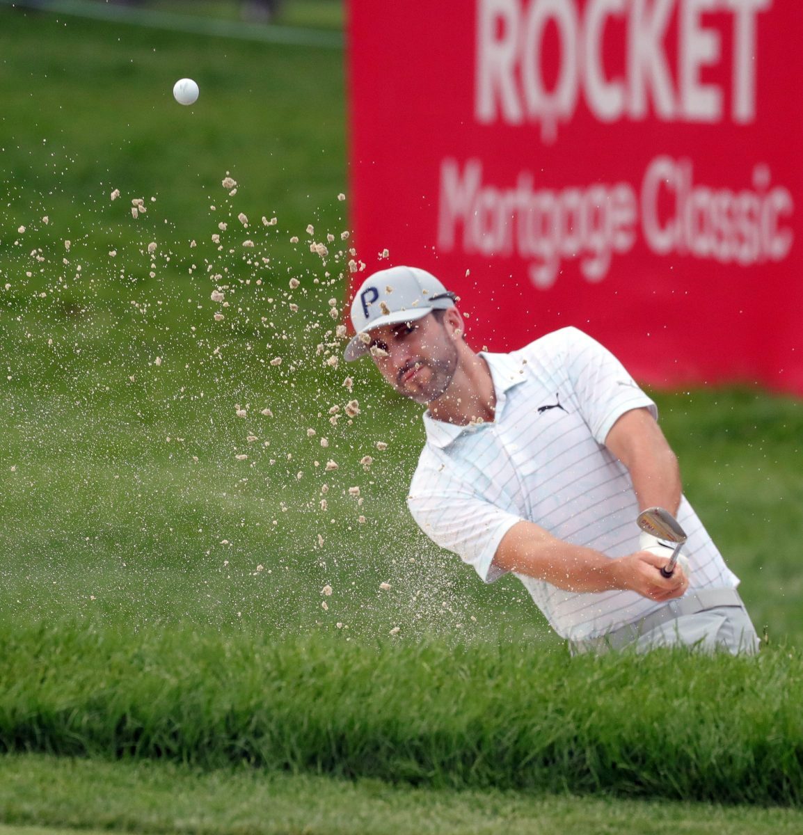 Chris Baker hits from the bunker on the 17th green during the third round of the Rocket Mortgage Classic at the Detroit Golf Club, Saturday, July 3, 2021. Kirthmon F. Dozier/USA Today Sports