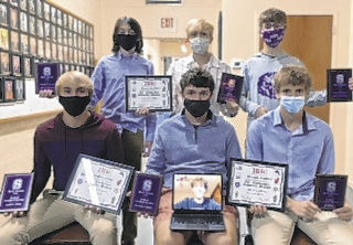 Mask-protected at their recent post-season ceremony, Seymour's tennis players pose with their recognition awards. Submitted photo