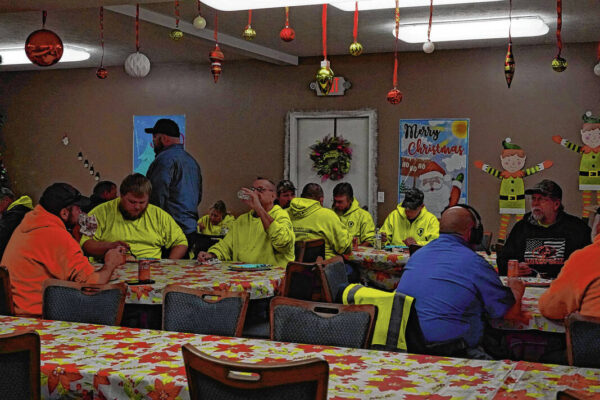 Volunteers serve meals to city workers